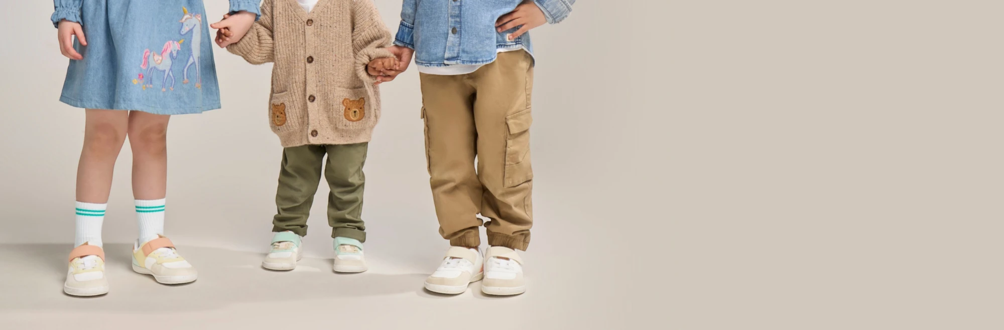 Group of children in studio wearing Rafferty’s Barefoot 1 kids barefoot shoes in different colourways.